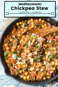 chickpea stew in a skillet with a wooden spoon