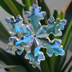 a snowflake ornament hanging from a tree