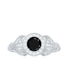 a black and white diamond ring on a white background with the center stone surrounded by diamonds