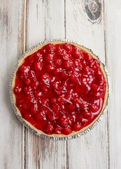 a cherry pie sitting on top of a wooden table