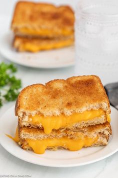 a grilled cheese sandwich on a white plate