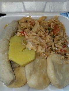 a plastic container filled with rice, meat and veggies next to banana slices