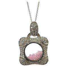 This stunning 18k diamond and pink sapphire shaker locket pendant has a total carat weight of 1.57 carats of diamonds and 7.14 carats of pink sapphire. The 18 inch chain can be shortened to 15.5 inches and the pendant measures 1.5 inches by 1 inch. Crafted in 18k white gold, this necklace is in excellent condition and perfect for any special occasion. 18k Diamond and Pink Sapphire Shaker Locket Pendant Necklace Condition: In good condition with some minor surface wear consistent with age. Measur Locket Pendant Necklace, Pink Sapphire, Gold Pendant, Locket, Sapphire, Jewelry Necklace Pendant, White Gold, Jewelry Necklaces, Pendant Necklace