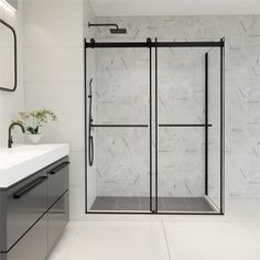 a bathroom with a sink, mirror and shower stall in white marbled tile on the wall