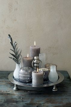 some candles are sitting on a plate with an inscription in the middle that says, it is