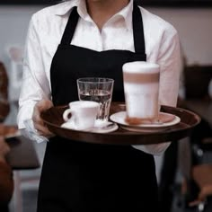 a waitress holding a tray with drinks on it