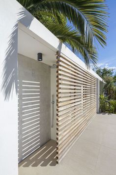 a white wall with wooden slats on it