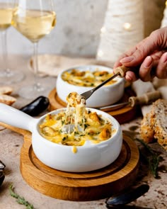 a person is dipping some food into a bowl