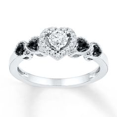 a white gold ring with black and white diamonds