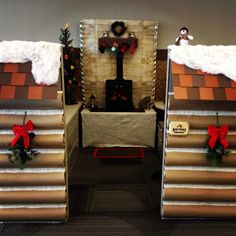 two cardboard houses with christmas decorations on them