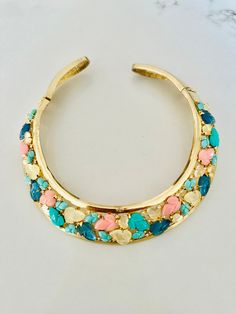 Gorgeous 1980's choker with no markings features colorful glass "fruit salad" stones found in Trifari jewelry. See last photo.   It is an unsigned beauty of costume jewelry that has been attributed to Lanvin.  I found a few online, and a similar color made in silver metal with blue stones.  It is one of those amazing mystery pieces.  Wide collar is made in gold tone cutout metal that is embellished with carved glass stones in pink, 2 shades of turquoise blue, opaque blue and a yellow opaque colo Multicolor Costume Jewelry Bangle, Multicolor Costume Jewelry With Stones, Multicolor Costume Jewelry Choker, Gold Collar Necklace, Prescott Az, Glass Fruit, Trifari Jewelry, Blue Stones, Shades Of Turquoise