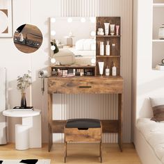 a wooden desk with a mirror above it in a living room next to a white couch