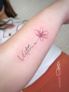 a woman with a tattoo on her arm that says,'victoria'in cursive writing