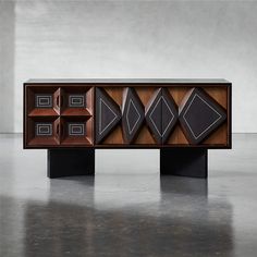 the sideboard is made out of wood and has geometric designs on it's sides