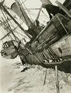 an old black and white photo of a boat in the snow