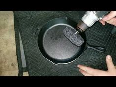 someone is using an electric drill to clean a frying pan