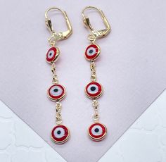 "Christmas season is a great period to give gifts. Enjoy a special collection just having you in mind. It's time to celebrate. Time to give, time to receive. Time to spread love. 18k Gold Filled Red Evil Eye Dangling Earring Our Etsy store was developed to help you find the most unique styles of modern designs, always looking for elegance and market trends. Here you will find ways to better make your jewelry through quality, seeking harmony, exclusivity and impeccable finish. Find many more styl Cheap Red Evil Eye Jewelry, Red Ear Wire Jewelry For Holidays, Red Jewelry For Holiday Jewelry Making, Red Hypoallergenic Jewelry For Party, Red Hypoallergenic Party Jewelry, Hypoallergenic Red Jewelry For Parties, Red Dangle Holiday Jewelry, Nickel Free Red Jewelry As Gift, Nickel-free Jewelry For Festivals And Gifts