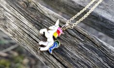 "This cute unicorn necklace would make a great gift. The unicorn is white, with rainbow hair, and measures just under 1\" wide. The necklace is a gold color and the chain length is adjustable. This would make a great gift for a birthday, an anniversary, Christmas or any other occasion. All jewelry items come in a gift box." Rainbow Novelty Jewelry For Birthday, Multicolor Unicorn Print Jewelry For Gift, Fun Rainbow Jewelry For Gifts, Rainbow Fun Jewelry For Gifts, Fun Rainbow Colored Jewelry For Gifts, Fun Rainbow Colored Jewelry Gift, White Unicorn Print Jewelry For Gifts, White Unicorn Print Jewelry For Gift, Fun Rainbow Necklaces For Gifts