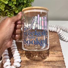 a person holding a coffee mug with writing on it