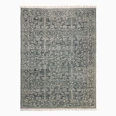 an antique rug with fringes on the edges and a design in grey, white and black