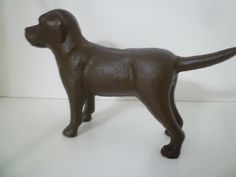 a brown dog figurine standing on a white surface