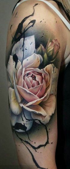 a woman's arm with a rose tattoo on it, and some black ink