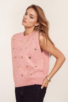 Introducing our Sleeveless Sweater in Pink with Silver Sequin Hearts – a cute and romantic addition to your wardrobe. This charming pink sweater features a delightful heart print in silver sequins, adding a touch of whimsy to your outfit.  Designed with a classic crew neckline, this sleeveless style offers a relaxed fit for both comfort and style. The soft knit fabric, crafted from a blend of 60% Polyester, 30% Polyamide, and 10% Wool, ensures a cozy feel against your skin.  The silver sequin hearts scattered across the sweater create a playful and eye-catching look, making it perfect for adding a romantic touch to your ensemble. Pair it with a black or white blazer for a chic and sophisticated outfit.  For sizing reference, the model is wearing size U, with measurements 33-24-35 and a hei Casual Pink Valentine's Day Sweater, Pink Sequined Crew Neck T-shirt, Winter Heart-shaped Sweater With Heart Print, Pink Heart-shaped Valentine's Day Sweater, Red Heart-shaped Valentine's Day Sweater, Midi Denim, Balloon Sleeve Top, Denim Midi Skirt, Silver Sequin