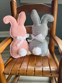 two crocheted stuffed animals sitting on top of a wooden chair