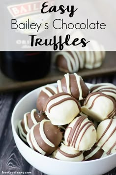 chocolate covered truffles in a white bowl on a wooden table with text overlay that reads easy bailey's chocolate truffles