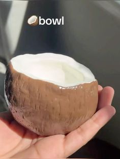 a person holding a half eaten coconut in their hand with the word wow above it