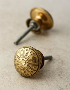 a close up of two knobs on a door with screws and nails in the background