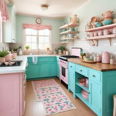 a pink and blue kitchen with lots of shelves on the wall above the stove top