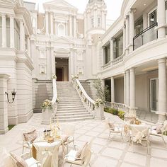 a large white building with many tables and chairs