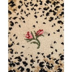 a close up of a rug with flowers on it