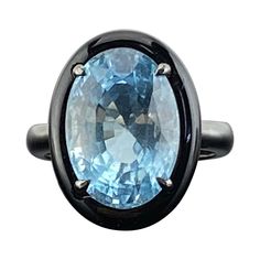 A stylish and classy ring, featuring a 7.76 carat aquamarine with a lovely sea-blue color. It is complemented by a piece of hand carved black onyx around it to give it a contrasting look . Hand-fabricated in 18K gold and polished in black rodium . The ring is currently sized at US 7, can be resized for free. We provide free express shipping world wide , and we gladly accept returns ! Please feel free to message us for more information. Luxury Blue Moonstone Ring, Formal Blue Moonstone Gemstone Ring, Luxury Blue Oval Moonstone Ring, Luxury Blue Topaz Ring With Polished Finish, Luxury Polished Blue Topaz Ring, Luxury Blue Oval Emerald Ring, Elegant Blue Moonstone Ring For Formal Occasions, Timeless Blue Topaz Gemstone Ring, Elegant Blue Sapphire Ring With Large Stone