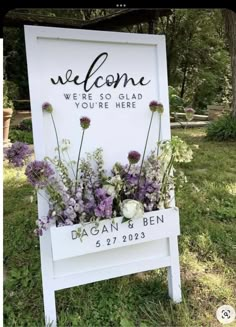 a welcome sign with flowers in it