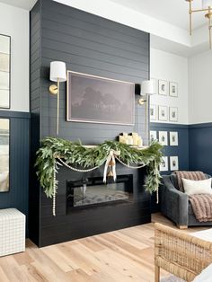 a living room filled with furniture and a fire place covered in greenery next to a fireplace