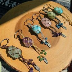 several different colored beads and charms on a wooden plate