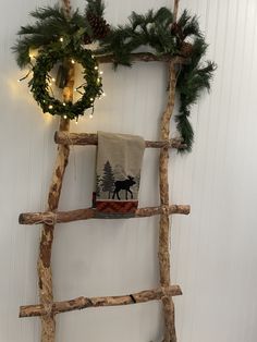 an old ladder is decorated with christmas wreaths and lights