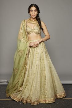 Editor's Note Light Yellow Embroidered Lehenga Set Fabric: Silk Organza, Chanderi Color: Light Yellow Care: Dry Clean Only About the Designer Itrh makes a high-end luxury Indian ethnic wear made using exquisite and endangered age-old crafts such as kalamkari, madhubani, chikankari, zardozi, and gota weaving. The focus of the house is to cherish the beauty of handcrafted luxury designer wear. Chikankari Lehenga, Gold Lehenga, Bridesmaid Lehenga, Metallic Blouses, Green Lehenga, Embroidered Lehenga, Traditional Indian Outfits, Sara Ali Khan, Ali Khan