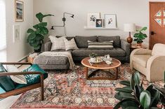 a living room filled with furniture and plants