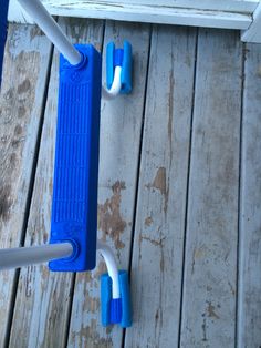 two blue and white handles on a wooden deck