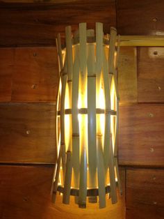 a light that is on the side of a wooden wall next to some wood planks