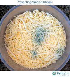 a bowl filled with cheese sitting on top of a counter