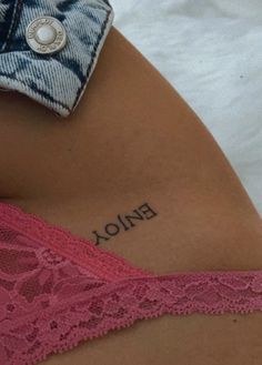 the back of a woman's stomach with her name tattoo on it