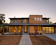 a modern house with wood siding and glass windows