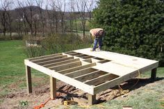 a man standing on top of a wooden structure