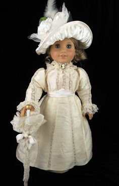 the doll is wearing a white dress and hat