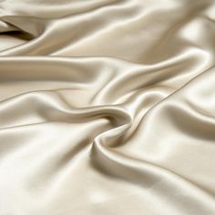 a close up view of a white satin fabric