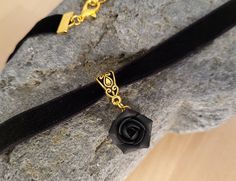 "Velvet choker necklace with black matt rose The rose is made of polymer clay. Each petal made by hand. Gorgeous gift for women and girls as handmade item Rose about 15 mm/ 0,6\" across. Metal bail in gold color  Length of necklace is adjustable: 10-12 inches/ 25,4 - 30,5 cm 11-13 inches/ 28-33 cm 12-14 inches/ 30.5- 35.5 cm 13-15 inches/ 33-38 cm 14-16 inches/ 35.5 cm-40.5 cm 15-17 inches/ 38,1 cm- 43,2 cm 16-18 inches/ 40.6 cm- 45.7 cm 17-19 inches/ 43 cm - 48 cm 18-20 inches 19-21 inches Width of ribbon 10 mm  If you need other length of necklace let me know and I will make it for you.   I make some custom orders. If you would like some items to be custom made or created for you in a special way, feel free to send an Etsy conversation with your requirements, and we can discuss them. If Elegant Rose Design Jewelry Choker, Elegant Rose Design Choker Jewelry, Black Necklace With Rose Design For Gift, Black Necklace With Rose Design As Gift, Elegant Black Jewelry With Rose Design, Black Rose Design Party Jewelry, Rose Design Choker Jewelry Gift, Rose Design Choker Jewelry For Gift, Rose Design Choker As Gift